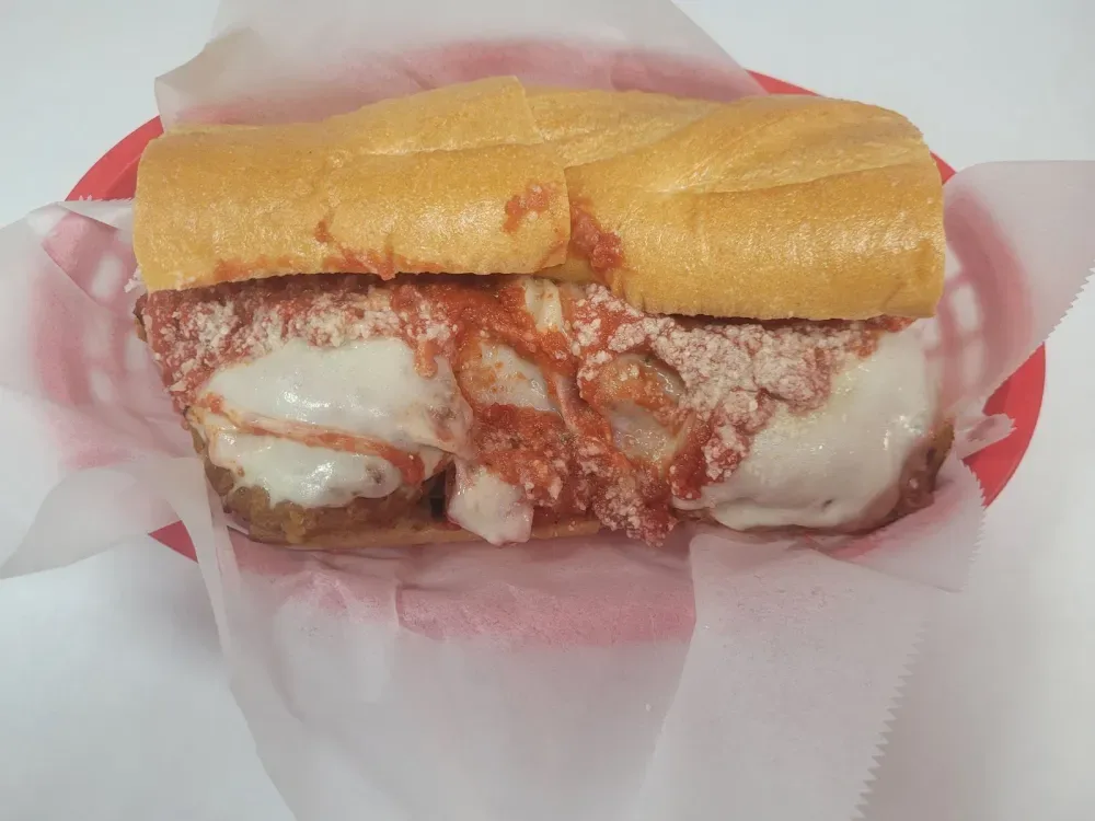 The Chicken Parm with breaded chicken, marinara, melted provolone, and grated Parmesan on a fresh Italian roll
